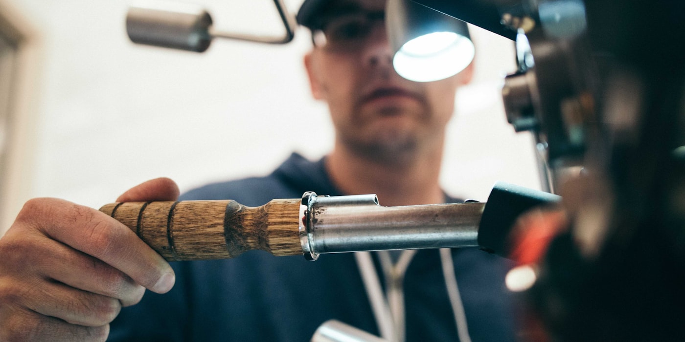 Professional plumber working on pipes