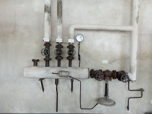 Plumber working on pipe repair under sink